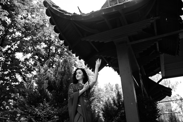 Portrait of beautiful indian brumette girl or hindu woman model against japanese traditional house