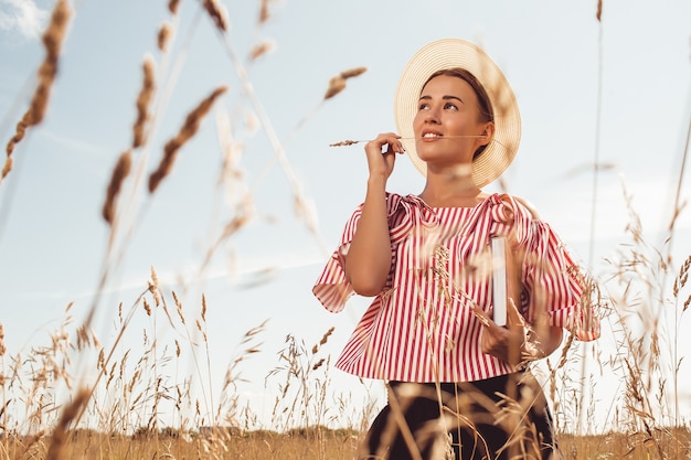 Portrait of a beautiful lady. reads a book in the field. prepare for university entrance.