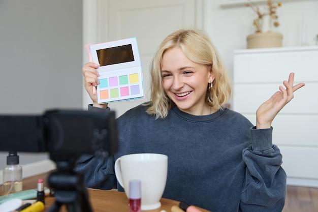 Portrait of beautiful lifestyle blogger girl records a video on her camera for social media shows