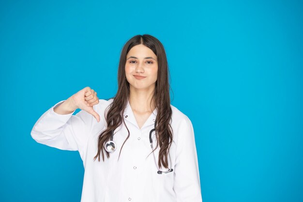 Portrait of beautiful mature woman doctor in lab coat for hospital shooting in studio