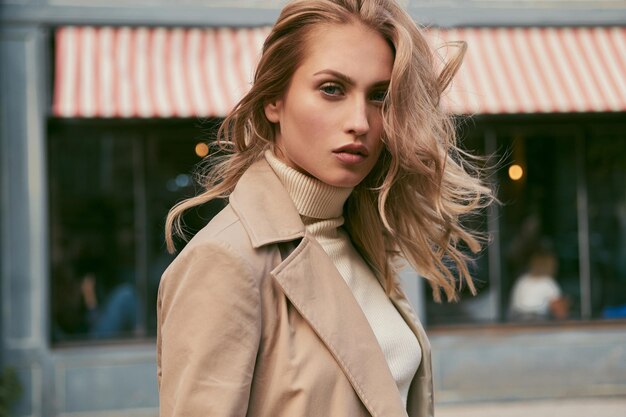 Portrait of beautiful pensive blond girl sensually looking in camera outdoor