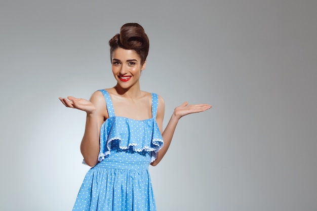 Portrait of beautiful pin-up woman at studio