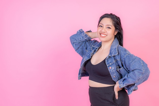 Portrait beautiful plump young woman smiling on pink