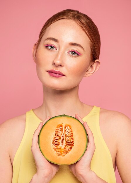 Portrait of beautiful redhead woman with fruit