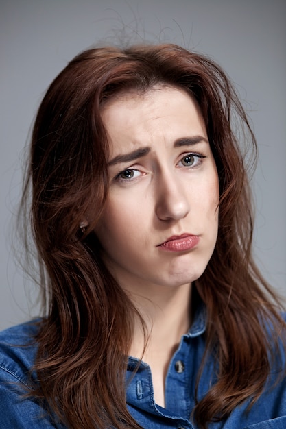 Free photo the portrait of a beautiful sad girl closeup