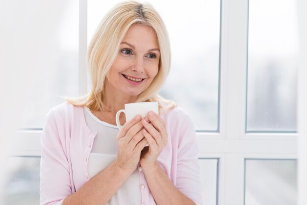 Portrait of beautiful senior woman with a cup