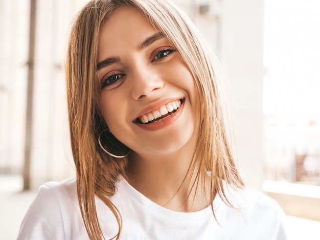 Portrait of beautiful smiling blond model dressed in summer hipster  clothes.  