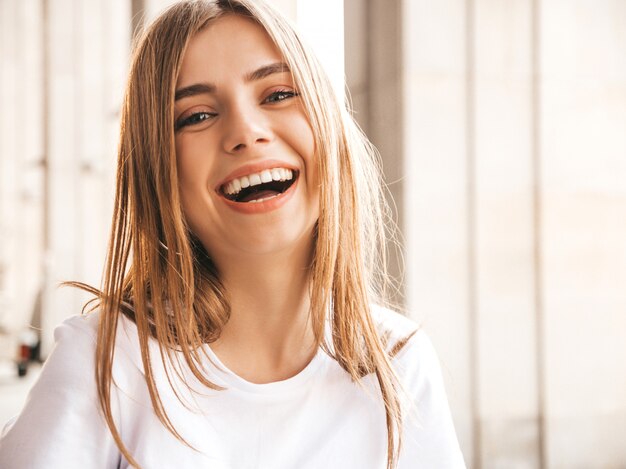 Portrait of beautiful smiling blond model dressed in summer hipster  clothes.  