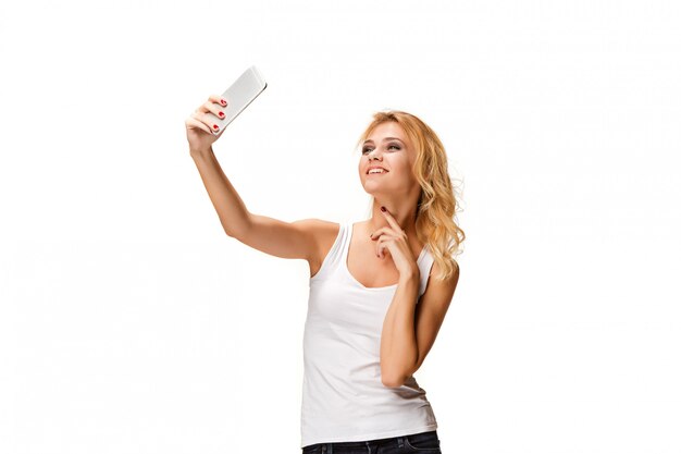 Portrait of beautiful smiling girl with modern smartphone