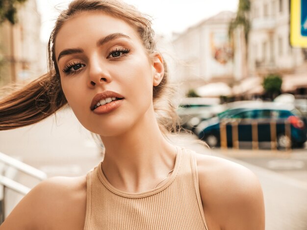 Portrait of beautiful smiling model dressed in summer hipster clothes