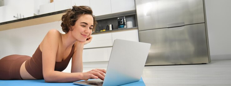 Free Photo portrait of beautiful sportswoman fitness girl watching videos on laptop during workout follow