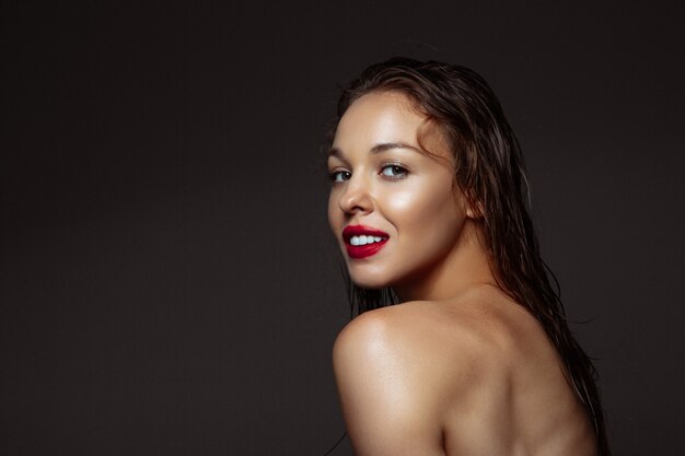 Portrait of beautiful stylish woman isolated on dark studio background