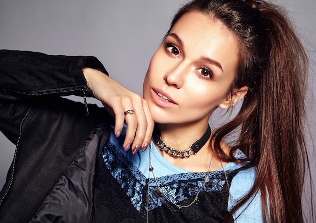 Portrait of beautiful stylish young woman touching her chin