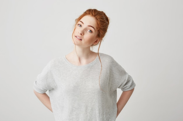 Portrait of beautiful tender redhead girl smiling posing .