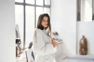 Free photo portrait of a beautiful woman in bathrobe indoors
