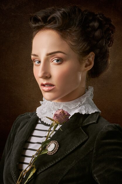 Portrait of the beautiful woman face with a rose