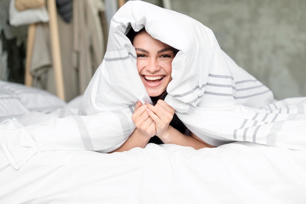 Portrait of beautiful woman happy in bed