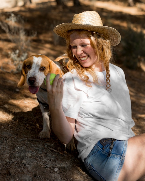 Portrait of beautiful woman and her dog playing