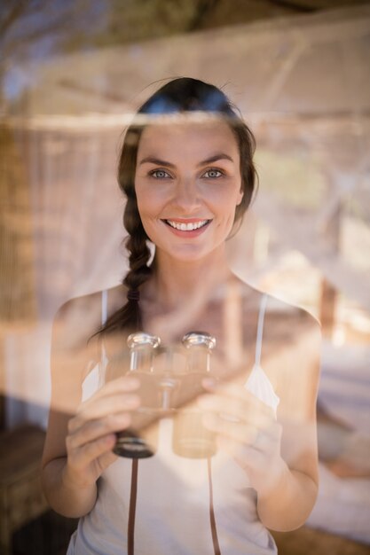 Portrait of beautiful woman holding binoculars