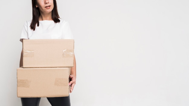 Portrait of beautiful woman holding boxes