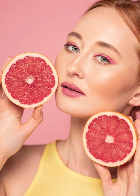 Portrait of beautiful woman holding fruits