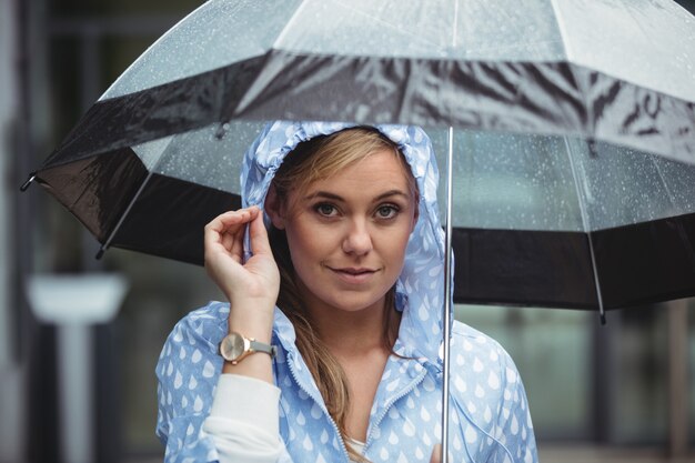 Portrait of beautiful woman holding umbrella