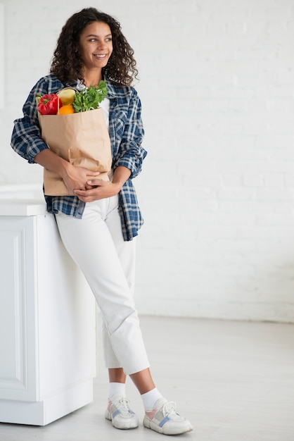 Portrait of beautiful woman holding vegetables bag