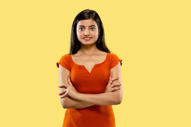 Portrait of beautiful woman isolated on yellow studio background