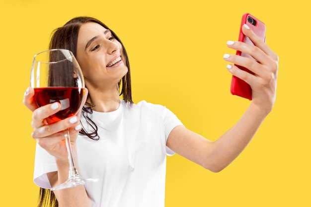 Portrait of beautiful woman isolated on yellow studio