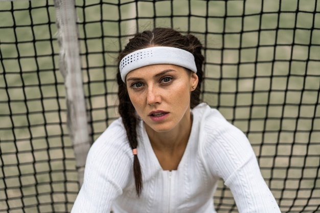 Portrait of beautiful woman playing tennis outdoor