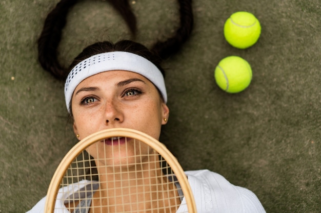 Portrait of beautiful woman playing tennis outdoor