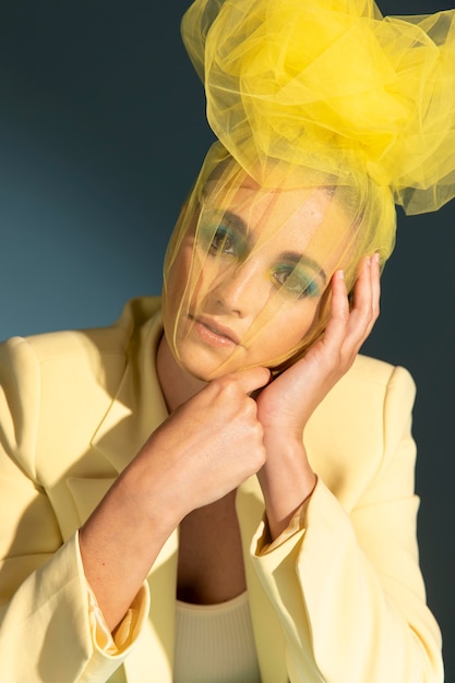 Portrait of beautiful woman posing with an avantgarde head peice