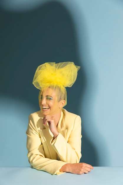 Portrait of beautiful woman posing with an avantgarde head piece