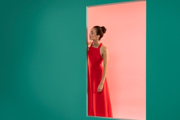 Portrait of beautiful woman posing with a flowy red dress