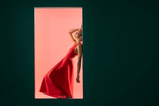 Portrait of beautiful woman posing with a flowy red dress