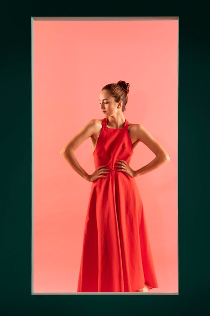 Portrait of beautiful woman posing with a flowy red dress