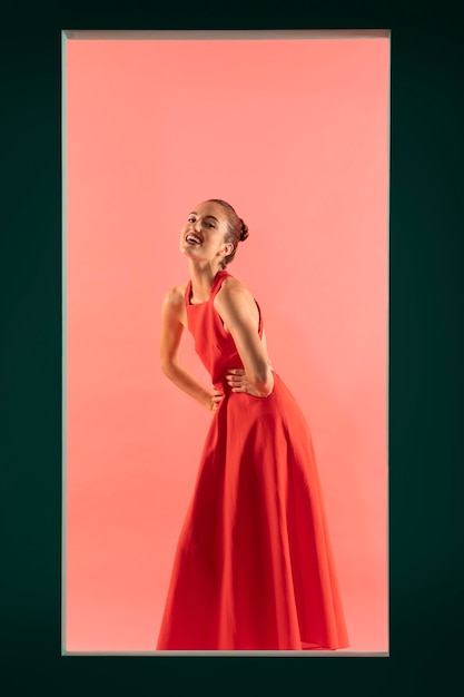 Portrait of beautiful woman posing with a flowy red dress