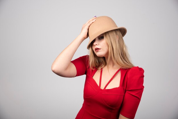 Portrait of beautiful woman posing with hat.