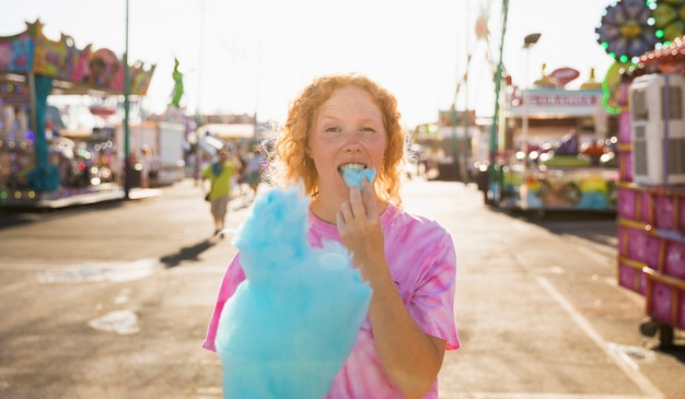 Portrait beautiful woman relishing cotton candy