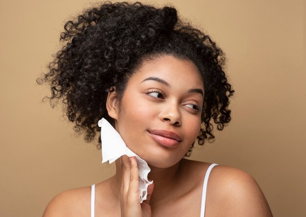 Portrait of a beautiful woman removing her make-up