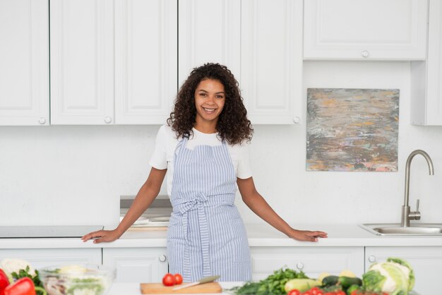Portrait of beautiful woman standing in kitchen