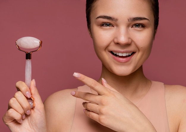 Portrait of beautiful woman using a jade roller