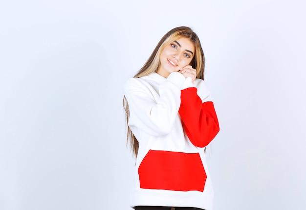 Portrait of a beautiful woman in warm hoodie standing and looking at camera 