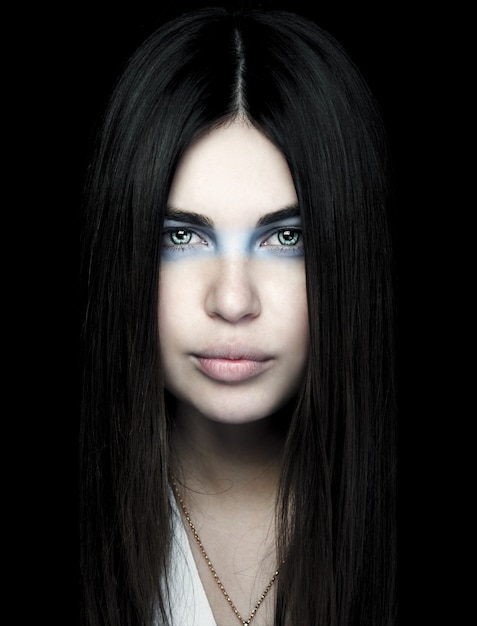 Portrait of beautiful woman with blue makeup around eyes