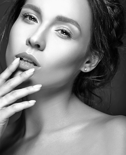 Portrait of beautiful woman with fresh daily makeup touching her mouth