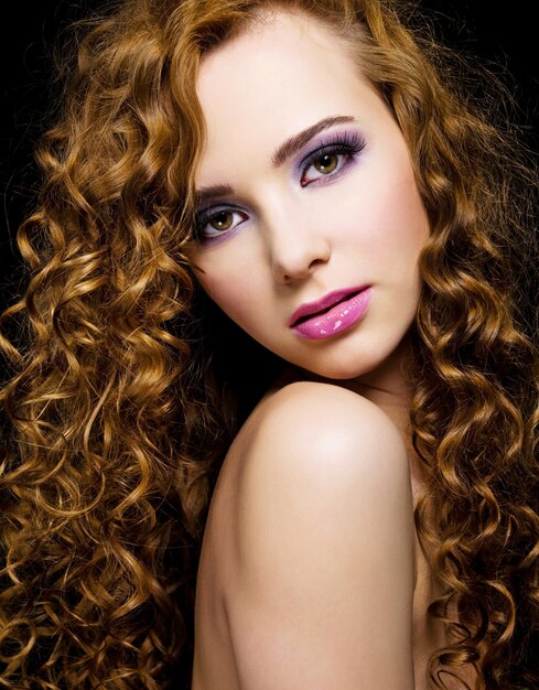 Portrait of a beautiful woman with long curly hairs