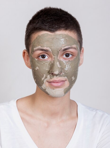 Portrait beautiful woman with mud treatment on face