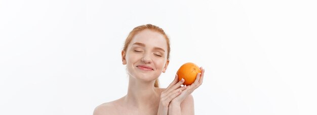 Portrait beautiful woman with a orange isolated