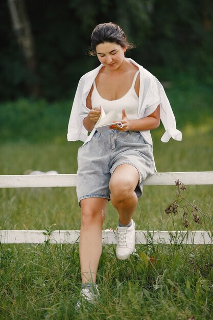 Portrait of beautiful woman. Woman read a book. Lady in a white shirt.