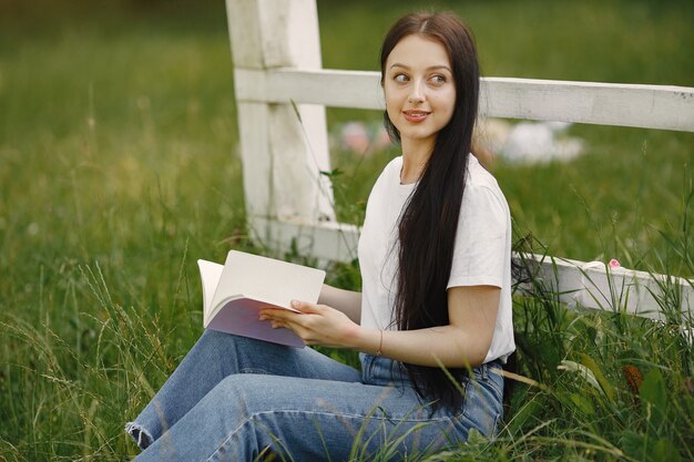 Portrait of beautiful woman. Woman read a book. Lady in a white shirt.